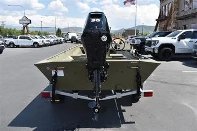 Slide: The Image of 2025 Lowe L1652MT Jon boat with motor, parked outdoors on a sunny day. - 6