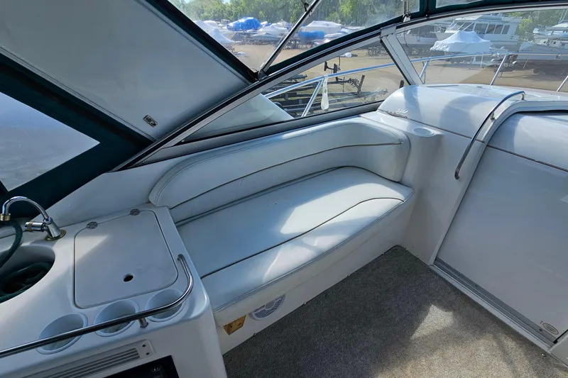 Slide: The Image of Interior of 2000 Larson Cabrio 330 boat with white seating and sink area. - 10