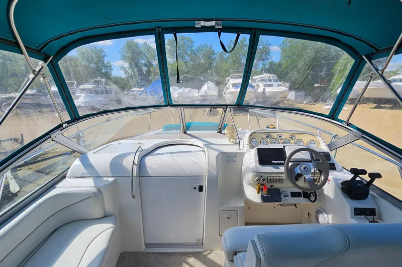 Slide: The Image of Interior view of a 2000 Larson Cabrio 330 boat cockpit with steering wheel and controls. - 13