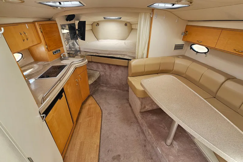Slide: The Image of Interior of 2000 Larson Cabrio 330 boat with kitchen, seating, and sleeping area. - 15