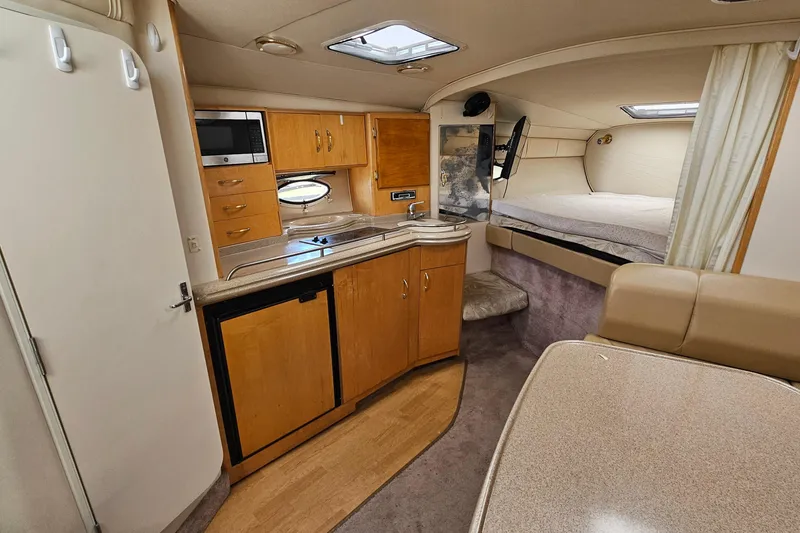 Slide: The Image of Interior of 2000 Larson Cabrio 330 boat with kitchenette and sleeping area. - 16