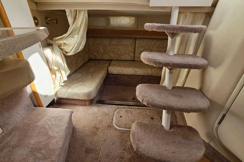 Slide: The Image of Interior of 2000 Larson Cabrio 330 boat with carpeted stairs and seating area. - 21