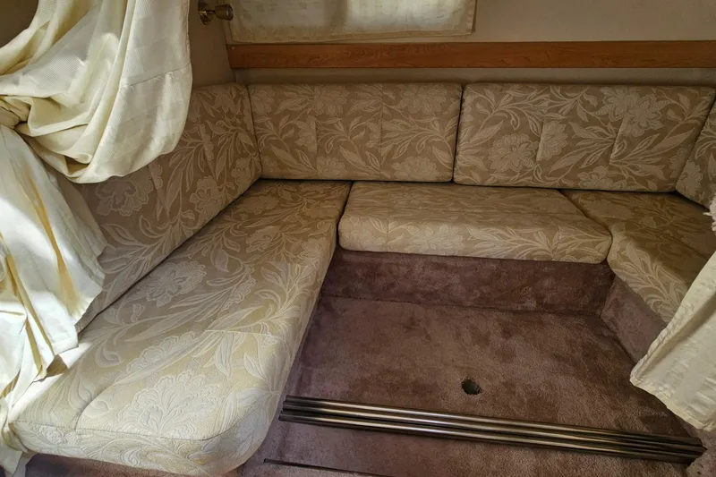 Slide: The Image of Interior seating of a 2000 Larson Cabrio 330 boat with floral upholstery. - 22