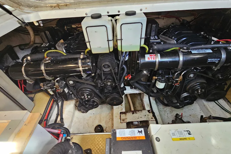 Slide: The Image of Engine compartment of a 2000 Larson Cabrio 330 boat, showcasing mechanical components. - 24