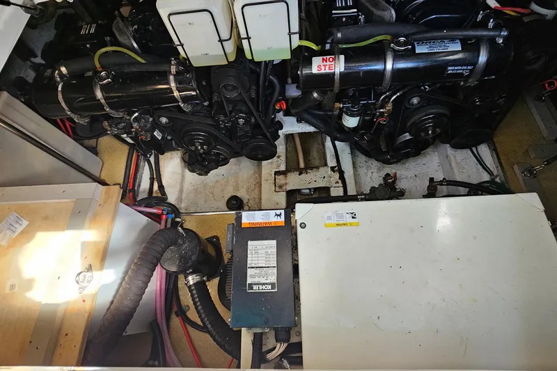 Slide: The Image of Engine compartment of a 2000 Larson Cabrio 330 boat, showcasing mechanical components. - 25