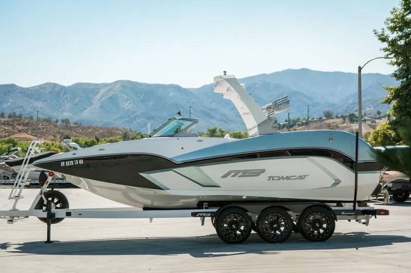 Slide: The Image of 2021 MB F24 Tomcat Alpha boat on trailer with mountain backdrop. - 10