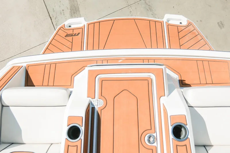 Slide: The Image of 2021 MB F24 Tomcat Alpha boat deck with orange and white design. - 14