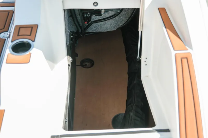 Slide: The Image of 2021 MB F24 Tomcat Alpha boat storage compartment with wood and padded interior. - 25