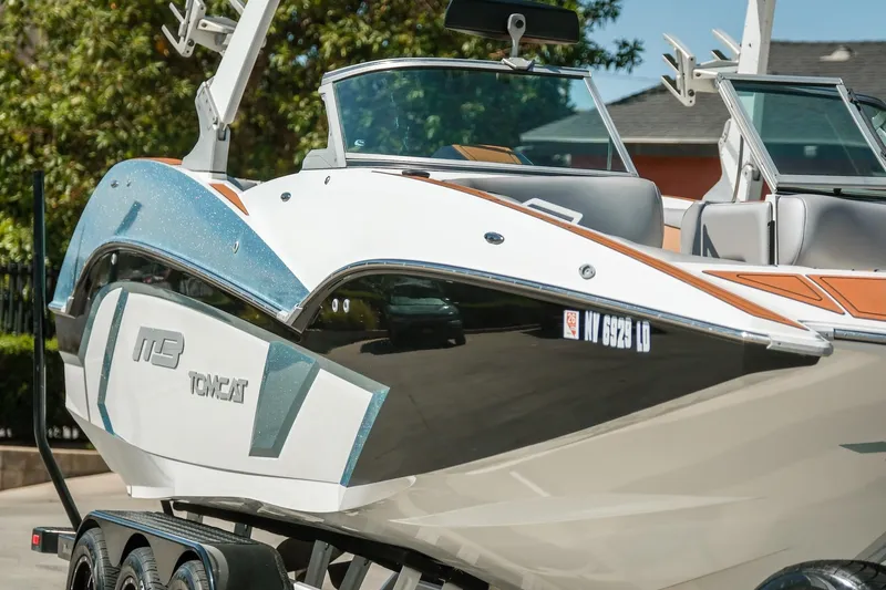 Slide: The Image of 2021 MB F24 Tomcat Alpha boat on trailer, sleek design, outdoor setting. - 8