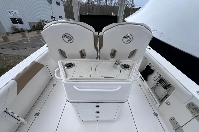 Slide: The Image of Edgewater 262CC 2022 boat interior with seating and storage compartments. - 10