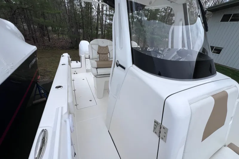 Slide: The Image of 2022 Edgewater 262CC boat with sleek white design and comfortable seating. - 14