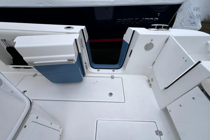 Slide: The Image of 2022 Edgewater 262CC boat interior with open storage compartments and sleek white design. - 21