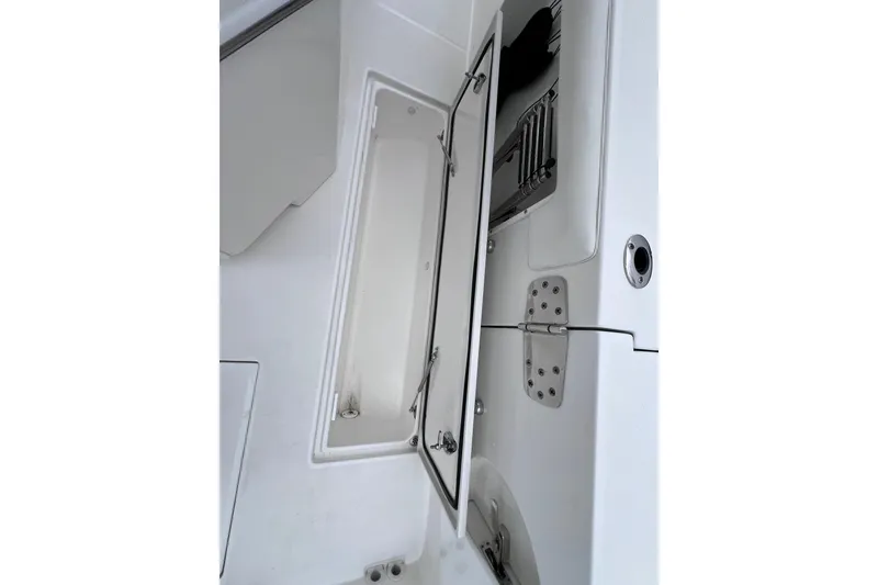 Slide: The Image of Open storage compartment on 2022 Edgewater 262CC boat, showcasing interior design. - 24