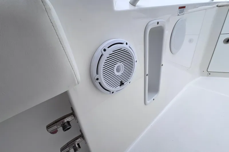 Slide: The Image of 2022 Edgewater 262CC boat interior with speaker and storage compartment. - 26