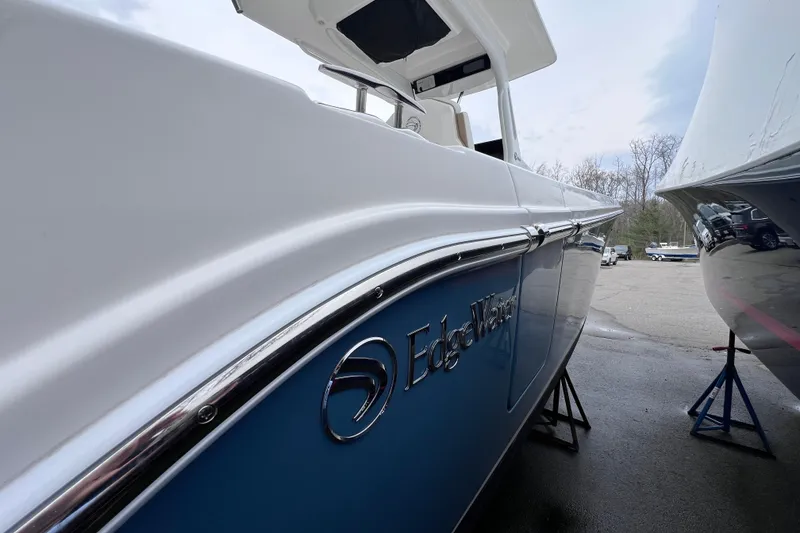 Slide: The Image of 2022 Edgewater 262CC boat in storage, showcasing sleek design and branding. - 5