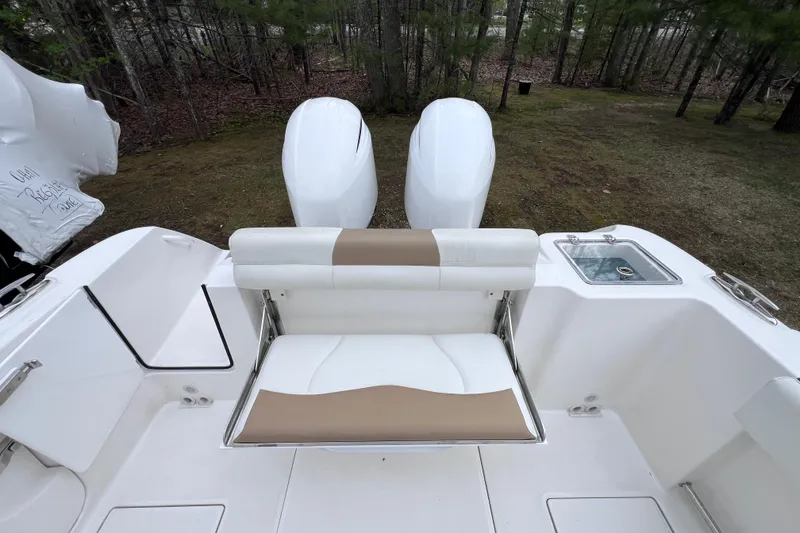 Slide: The Image of 2022 Edgewater 262CC boat interior with dual engines and seating area. - 9