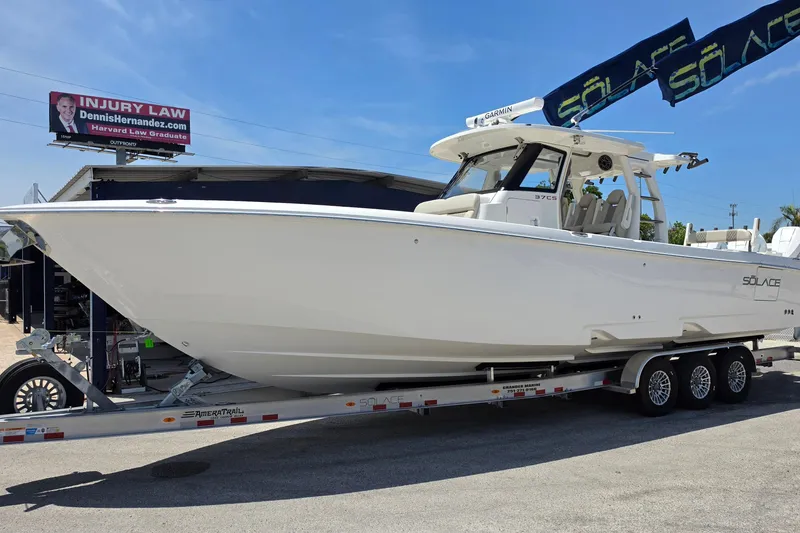 The Image of 2025 Solace 37CS boat on trailer under clear blue sky. - 1