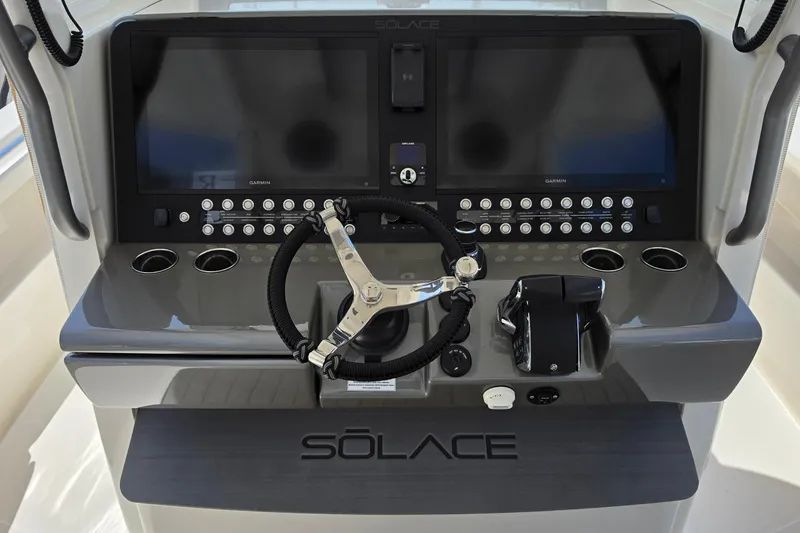 Slide: The Image of 2025 Solace 37CS boat dashboard with dual screens and modern controls. - 12