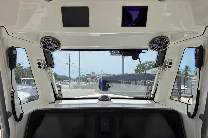 Slide: The Image of Interior view of 2025 Solace 37CS boat cockpit with speakers and communication devices. - 13