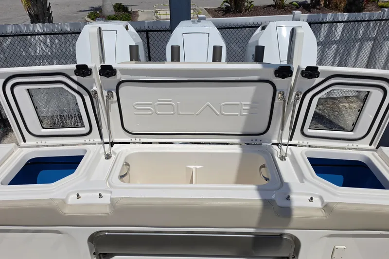 Slide: The Image of 2025 Solace 37CS boat storage compartments with open lids, showcasing interior design. - 17