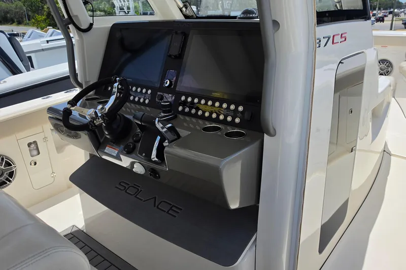 Slide: The Image of Helm of 2025 Solace 37CS boat with advanced navigation controls and steering wheel. - 19