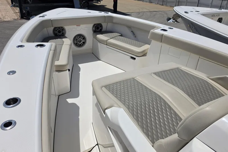 Slide: The Image of 2025 Solace 37CS boat interior with cushioned seating and built-in speakers. - 21