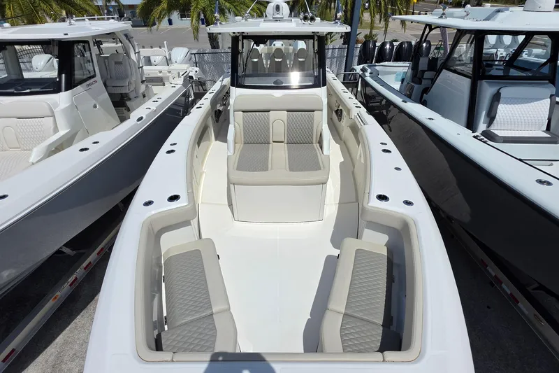 Slide: The Image of 2025 Solace 37CS boat with spacious seating and modern design in a marina setting. - 24