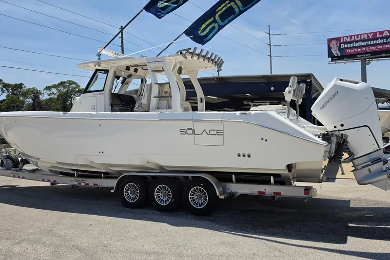 Slide: The Image of 2025 Solace 37CS boat on trailer, featuring sleek design and powerful Mercury engines. - 3