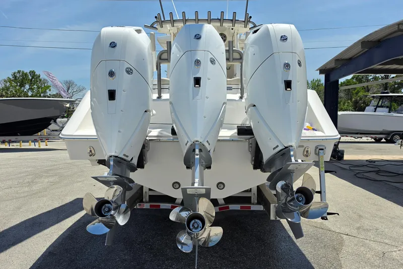 Slide: The Image of 2025 Solace 37CS boat with triple outboard engines, docked in a marina. - 4