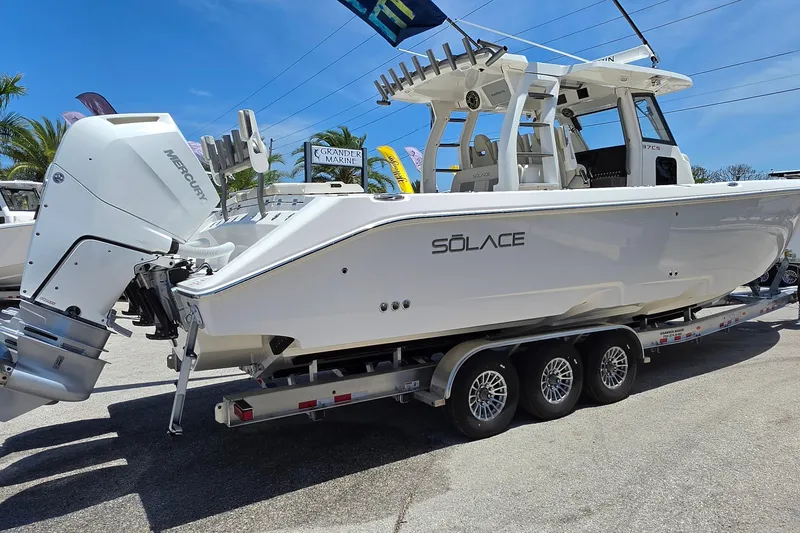 Slide: The Image of 2025 Solace 37CS boat on trailer with Mercury outboard engine, displayed outdoors. - 5