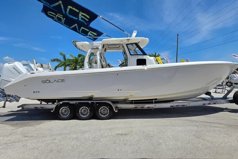 Slide: The Image of 2025 Solace 37CS boat on trailer under blue sky, showcasing sleek design. - 6