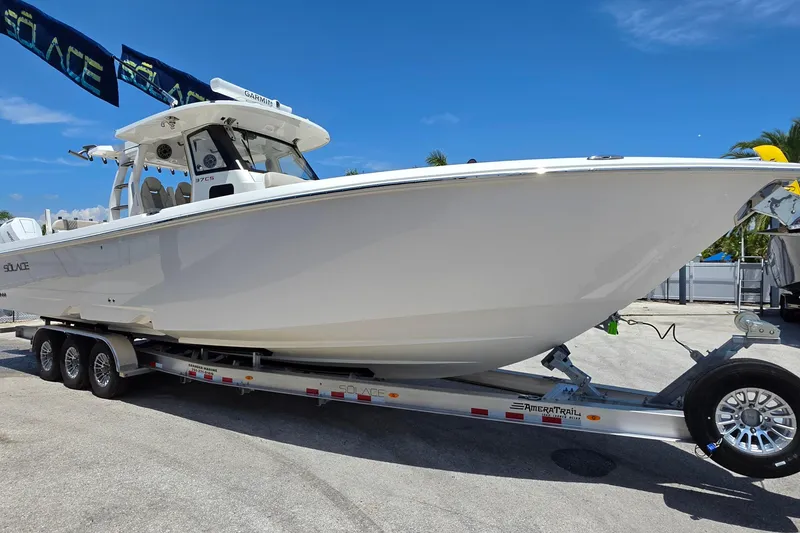Slide: The Image of 2025 Solace 37CS boat on trailer under clear blue sky. - 7