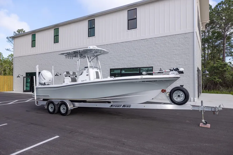 The Image of 2022 BlackJack 256 Coastal boat on trailer, parked outside a modern building. - 1