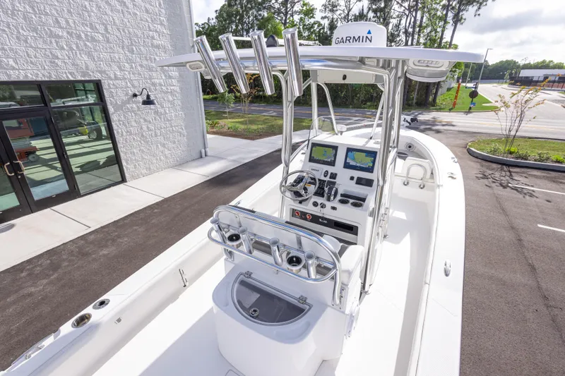 Slide: The Image of 2022 BlackJack 256 Coastal boat with advanced Garmin navigation system, docked near a modern building. - 12