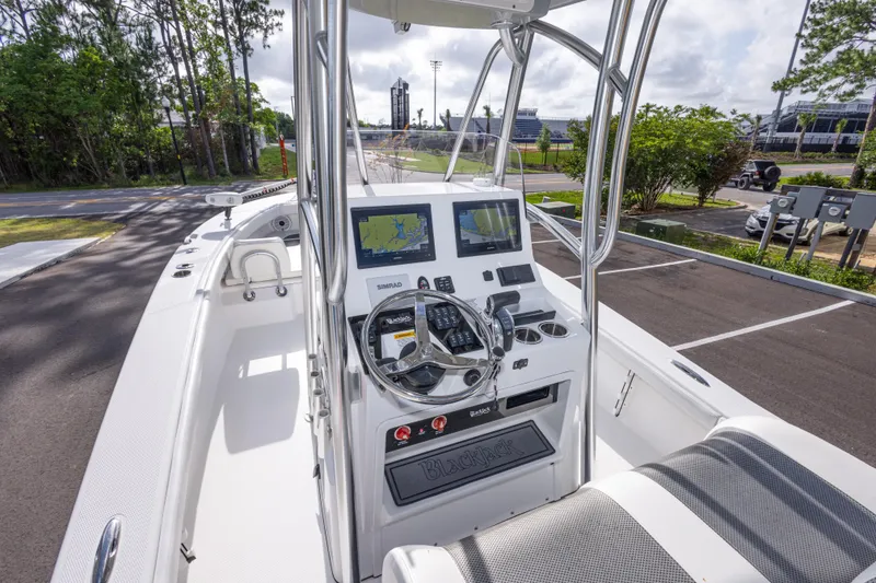 Slide: The Image of 2022 BlackJack 256 Coastal boat interior with navigation system and steering wheel. - 15