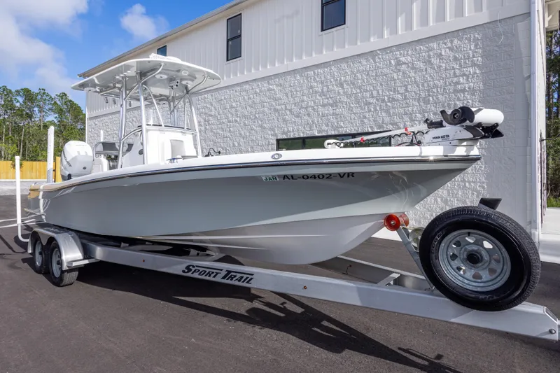 Slide: The Image of 2022 BlackJack 256 Coastal boat on trailer, parked outside a building. - 3