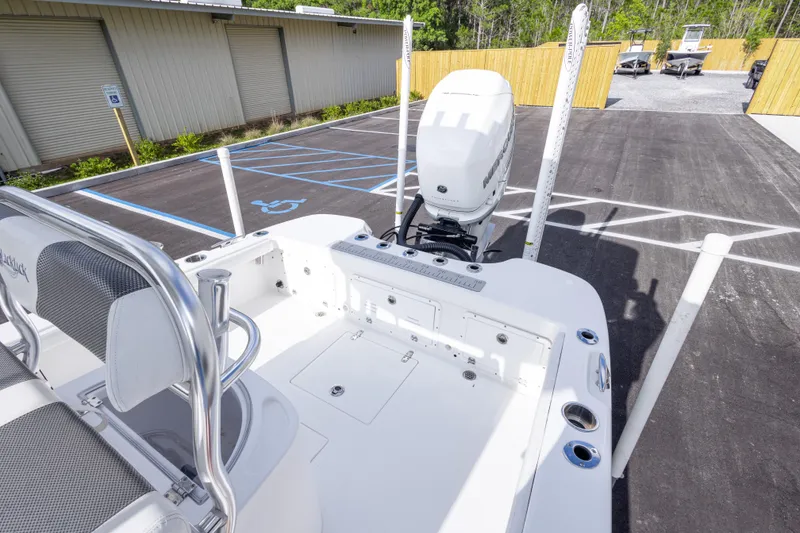 Slide: The Image of 2022 BlackJack 256 Coastal boat with outboard motor in a parking lot. - 31