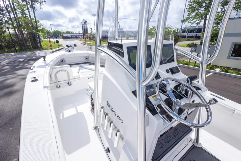 Slide: The Image of 2022 BlackJack 256 Coastal boat interior with steering console and navigation equipment. - 34