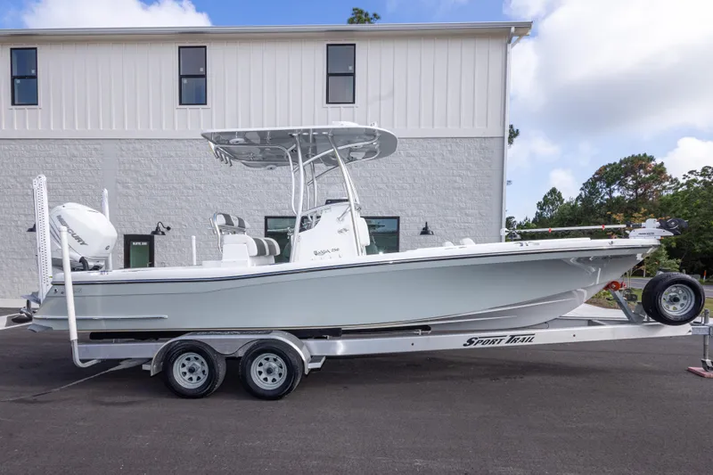 Slide: The Image of 2022 BlackJack 256 Coastal boat on trailer, parked outside a building. - 4