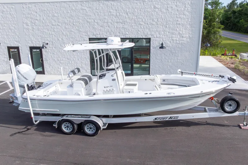 Slide: The Image of 2022 BlackJack 256 Coastal boat on trailer, parked outside a modern building. - 41