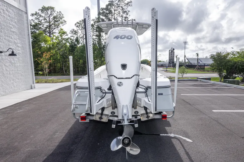 Slide: The Image of 2022 BlackJack 256 Coastal boat with powerful outboard motor in a parking lot. - 6