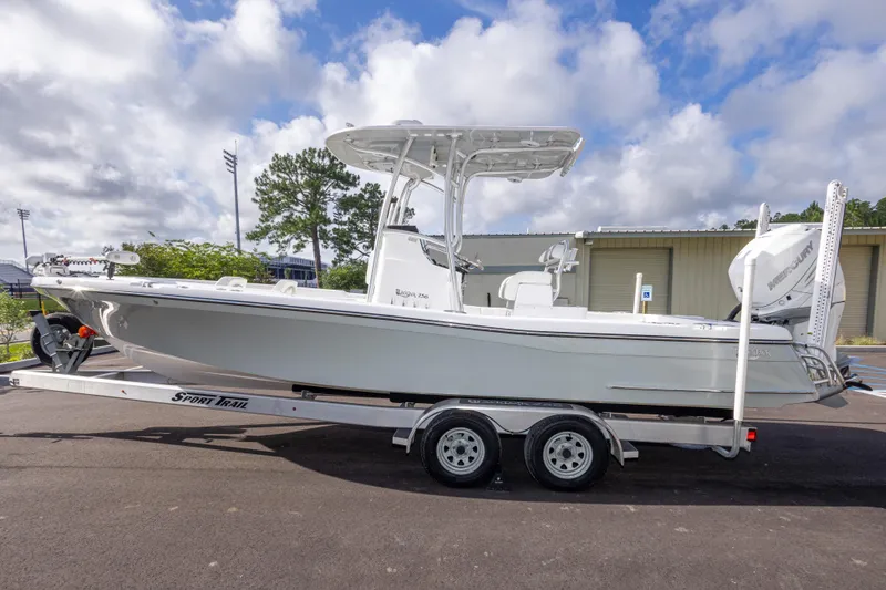 Slide: The Image of 2022 BlackJack 256 Coastal boat on trailer, parked outdoors under cloudy sky. - 8