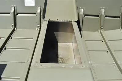 Slide: The Image of 2025 Lowe L1648M Jon boat interior storage compartment, open lid, metal construction. - 11