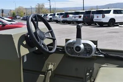 Slide: The Image of 2025 Lowe L1648M Jon boat steering console in a parking lot. - 12