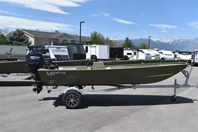 Slide: The Image of 2025 Lowe L1648M Jon boat on trailer, parked outdoors with mountains in background. - 4