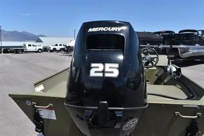Slide: The Image of 2025 Lowe L1648M Jon boat with Mercury 25 horsepower outboard motor, parked outdoors. - 7