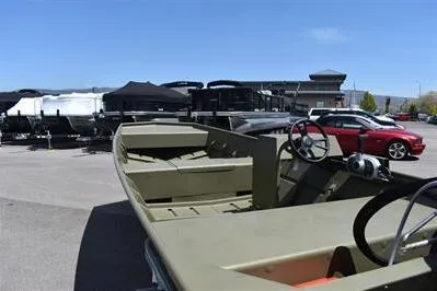 Slide: The Image of 2025 Lowe L1648M Jon boat in parking lot, showcasing interior and steering wheel. - 8