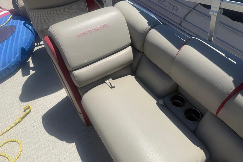 Slide: The Image of 2019 Berkshire 23RFX STS boat seat with cup holders and adjacent inflatable tube. - 11
