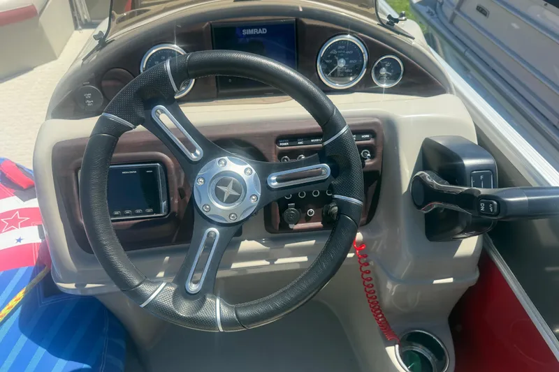 Slide: The Image of Steering wheel and dashboard of a 2019 Berkshire 23RFX STS boat. - 12