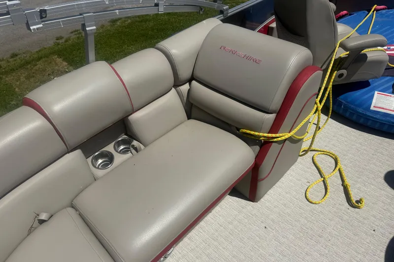 Slide: The Image of 2019 Berkshire 23RFX STS boat interior with beige seating, cup holders, and yellow rope. - 13